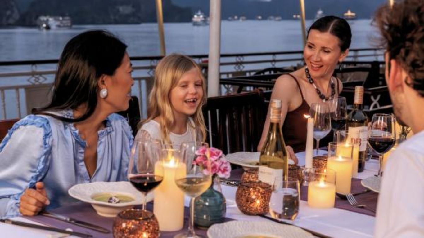 A family having a meal on a Halong Bay junk boat cruise lounge